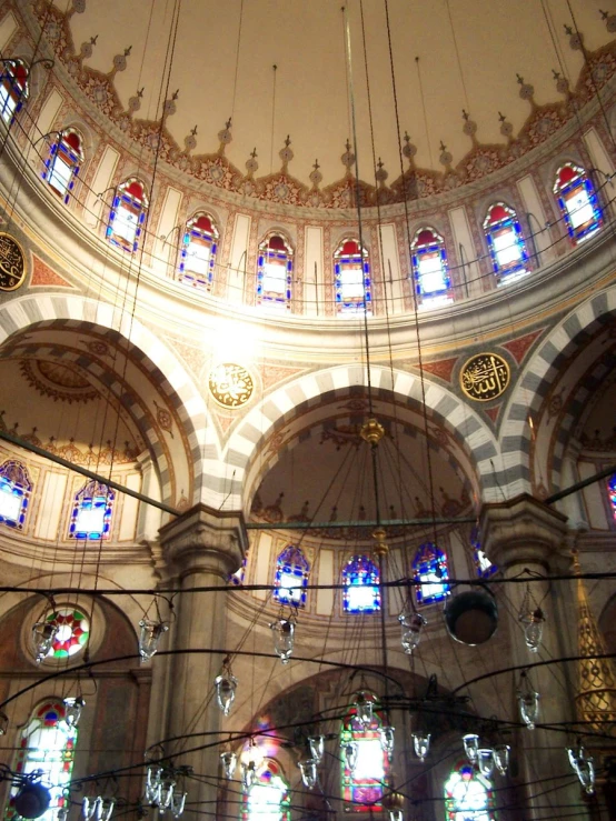 a domedly decorated ceiling with chandeliers in a building