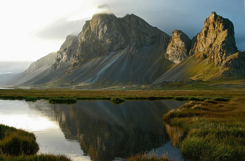 a lake surrounded by two very tall mountains