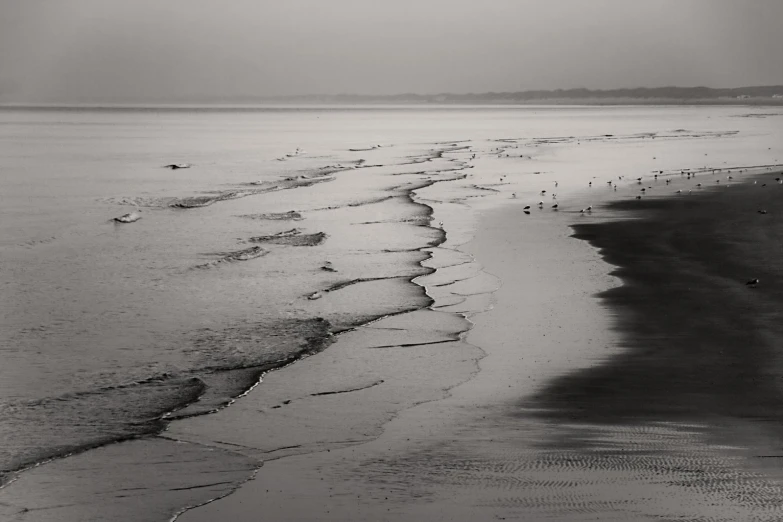 black and white pograph of the beach with lots of sand