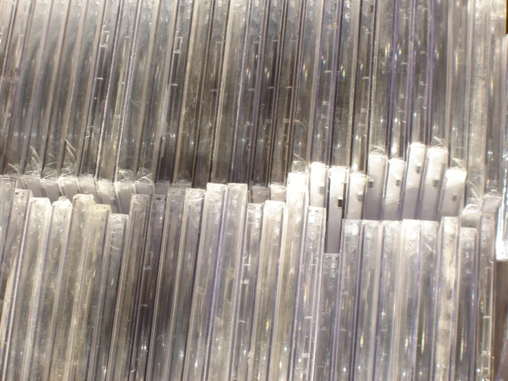 many toothbrushes in large plastic tubs lined up