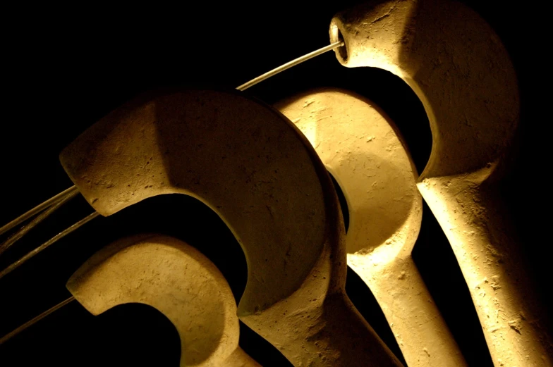 large metal tools are sitting on display in the dark