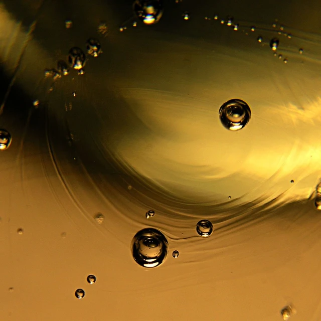 a yellow liquid splashing down into the air