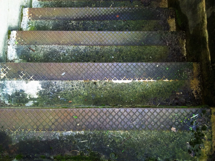 a stair case has worn off metal steps