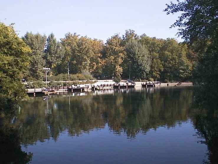 there is some boats in the water and trees