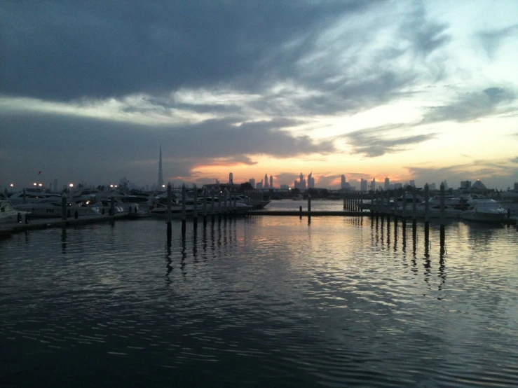 the evening view from an ocean pier of buildings