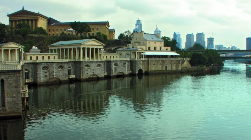 the view from across a river near several buildings