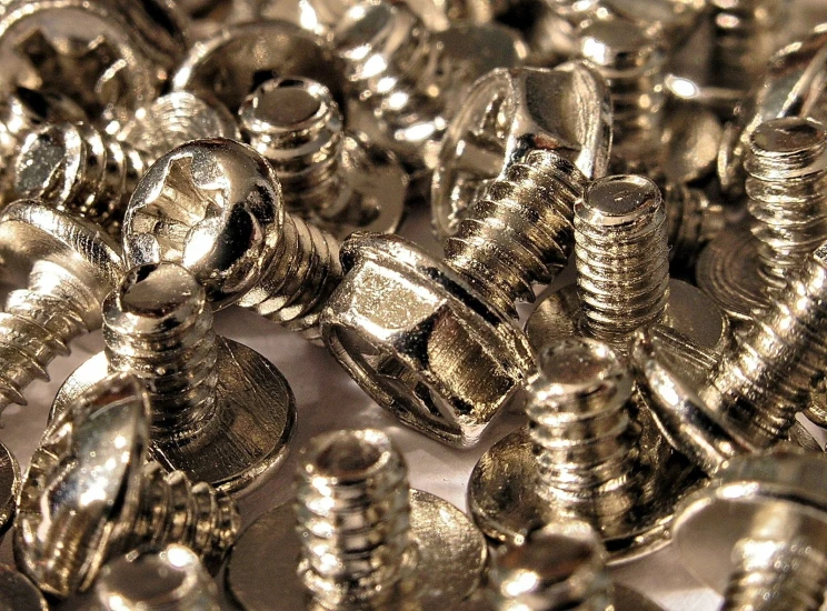 silver screws and metal rivets on a table