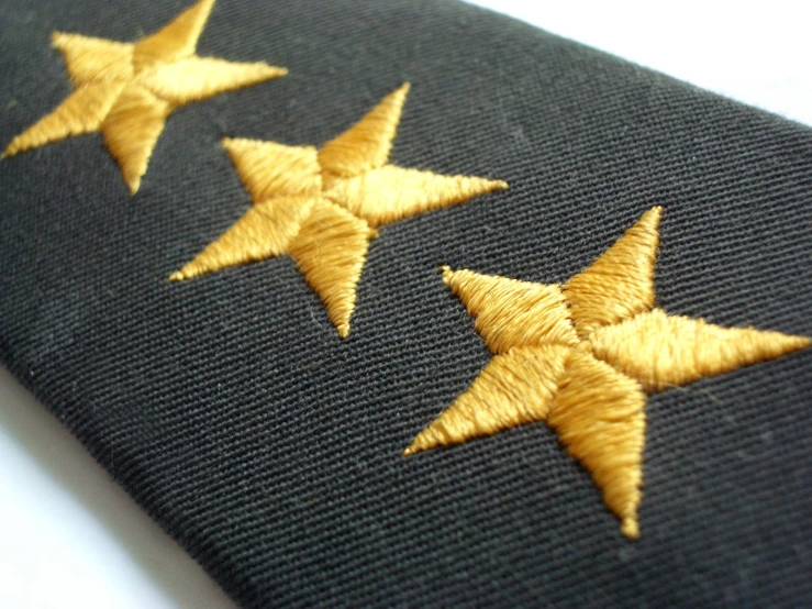 five gold stars on a black neck tie