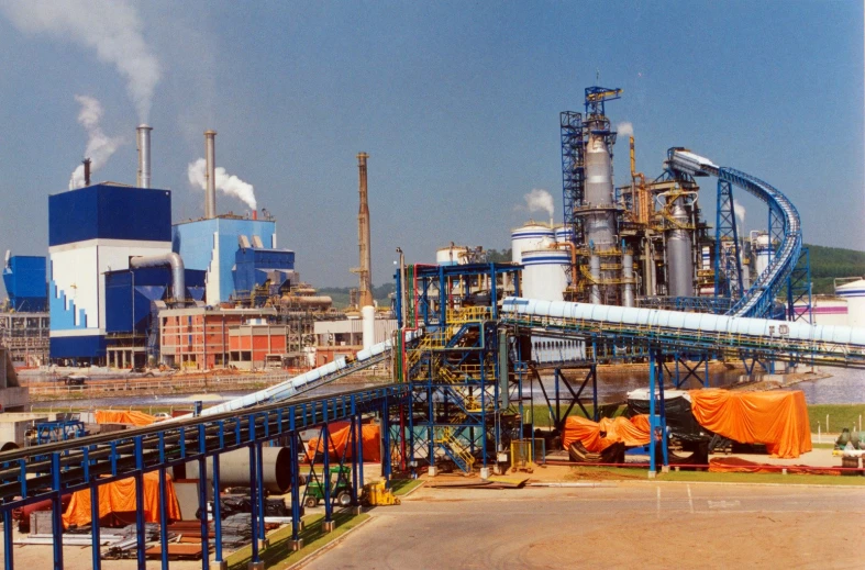 a factory is shown with smoke coming out of stacks