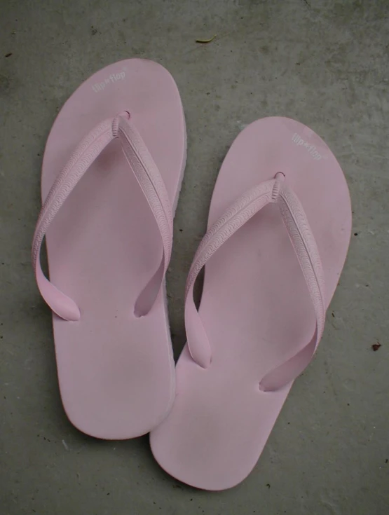 there are two pairs of pink sandals, one with a strap