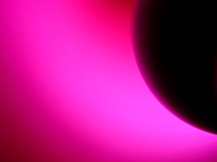 a very bright colored wall with a black and pink light in it