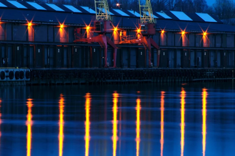a dock is lit up at night with several lights