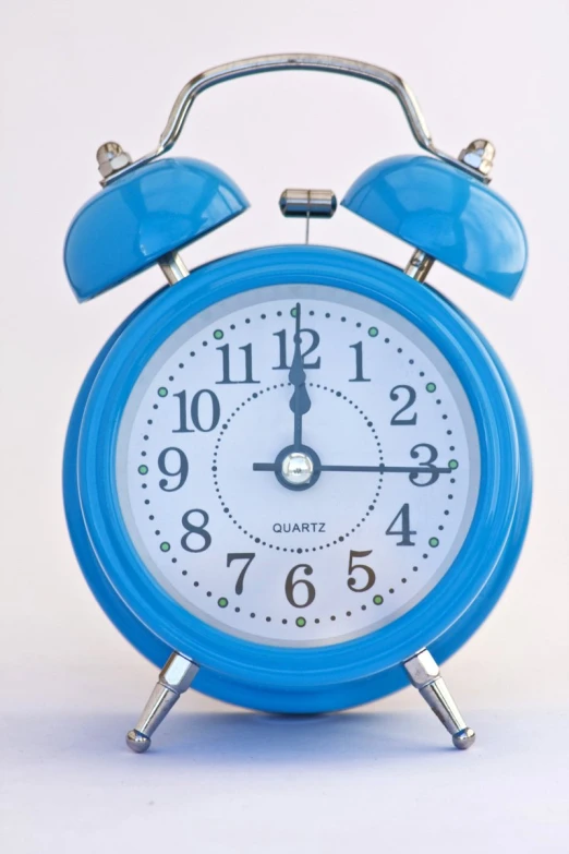 a blue alarm clock is turned to the right