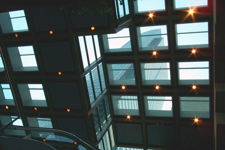 the top of a building looking up into its lit atrium