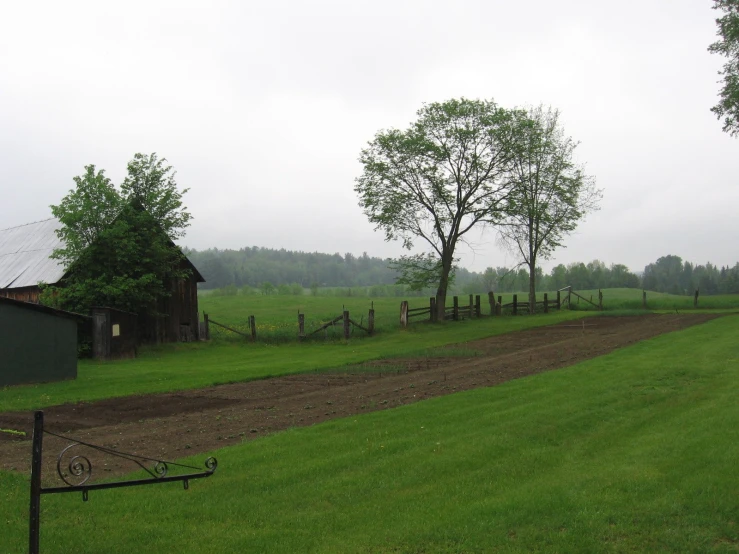 the green fields have grass and dirt in them