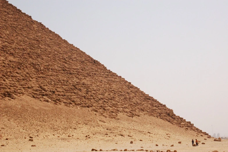 a big triangle with people walking by it