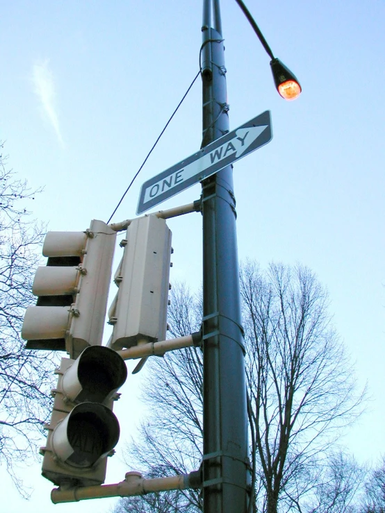 an old street lamp has a one way sign