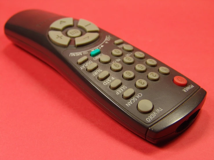 the remote control for a sony television sitting on a pink table