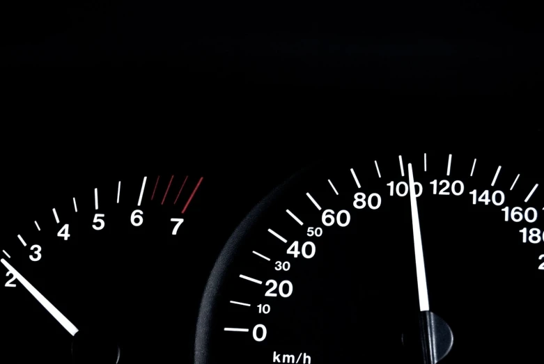 dashboard lights in the back of a car on a black background