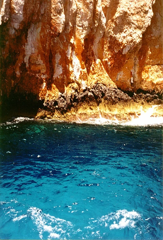 the water is blue, but it looks like it is on the cliffs