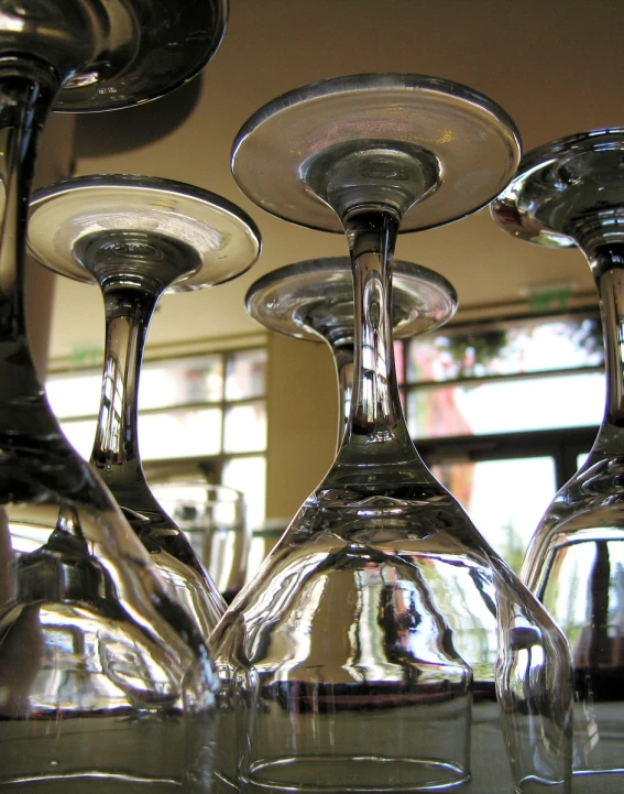 several wine glasses sitting next to each other on a table
