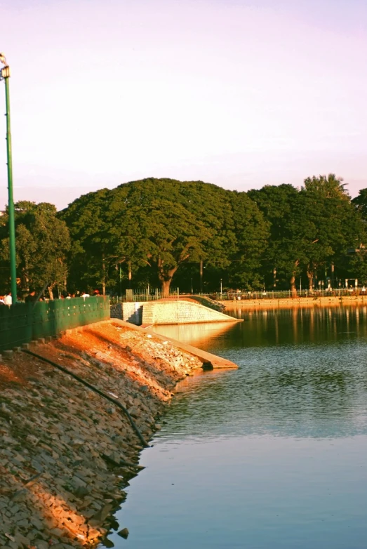 a view of water next to a green street light