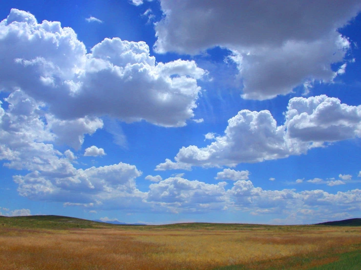 the field is empty in front of some clouds