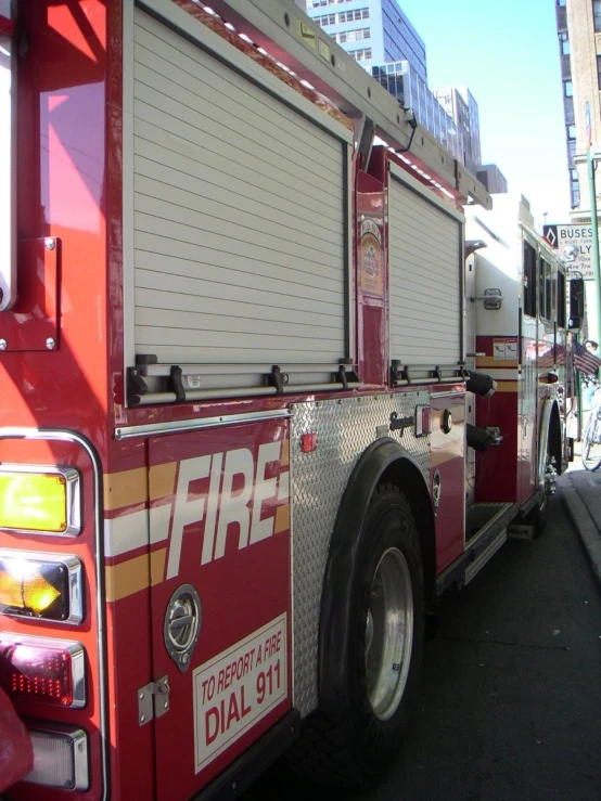 a fire truck driving past a tall building