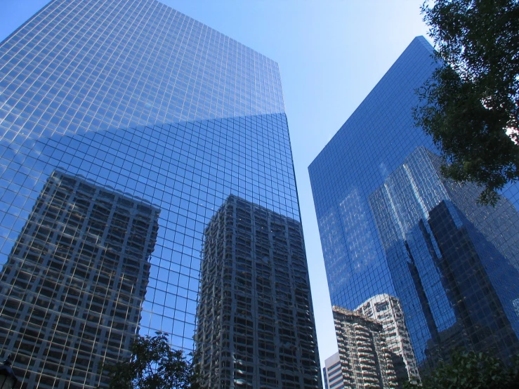 multiple buildings with blue glass reflecting each other