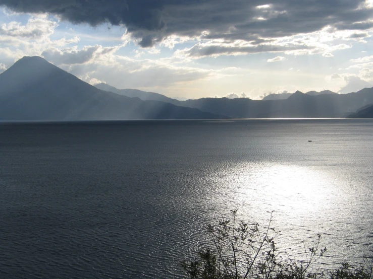 water with mountains and clouds on a bright day