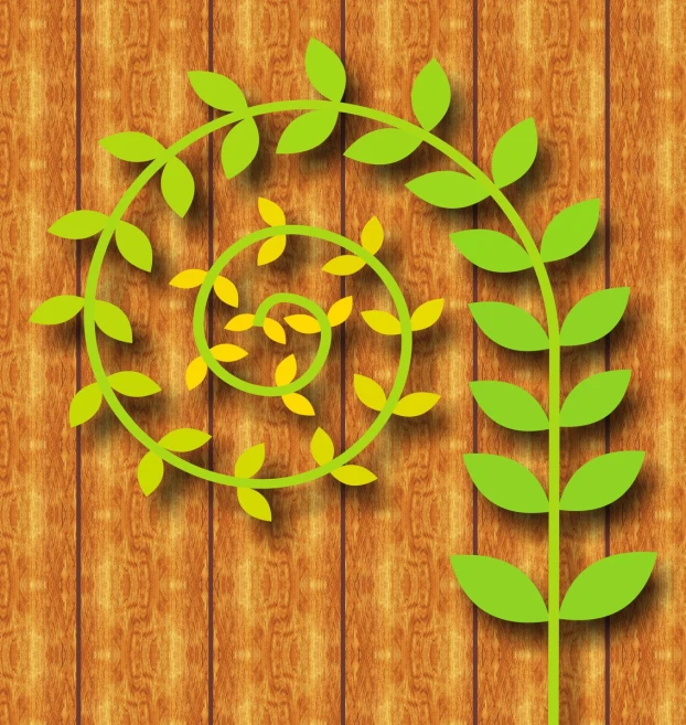 a paper cut out of a plant next to a wooden wall