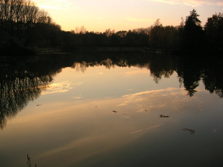 the sunset shines on the calm lake