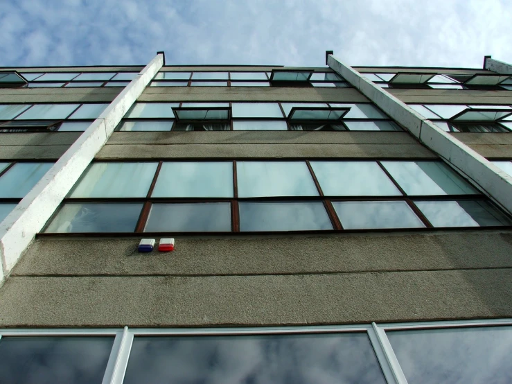 a building with windows and a stop sign on the side of it