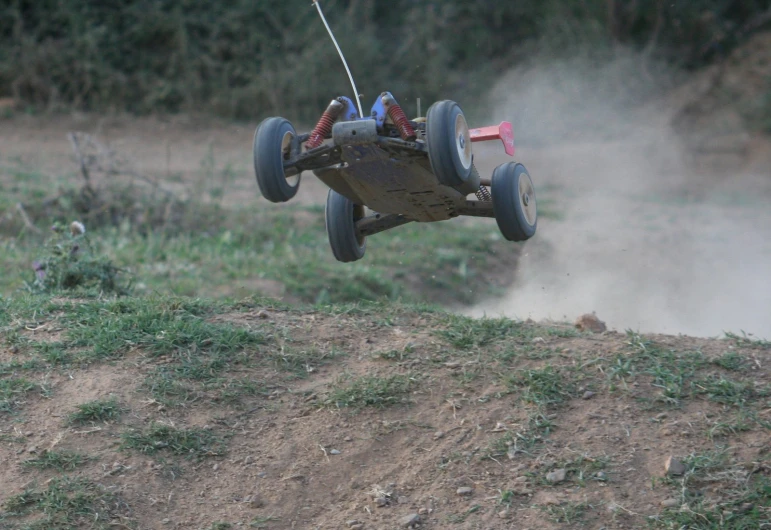 a toy car being used by a boy who is sliding down a hill