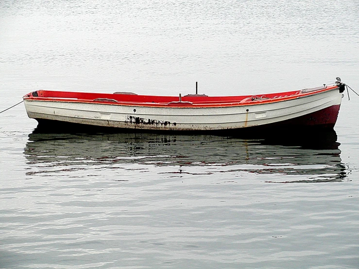 an empty boat floating on top of a body of water