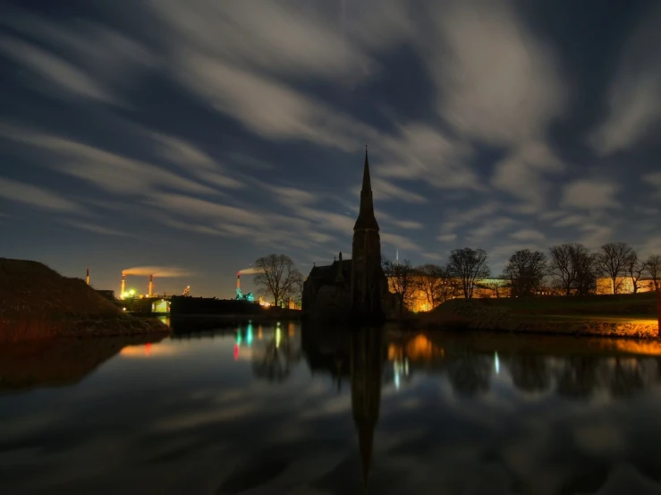 the night sky is overcasting an ancient building