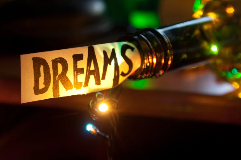 a key chain with the word dreams written on it