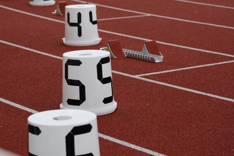 numbered markers placed on a track near an american flag