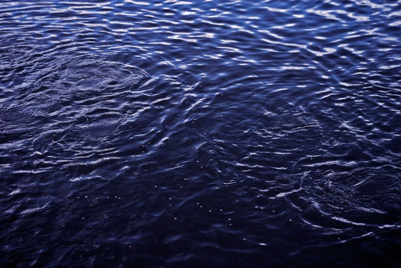 some water that is very dark blue and rippled