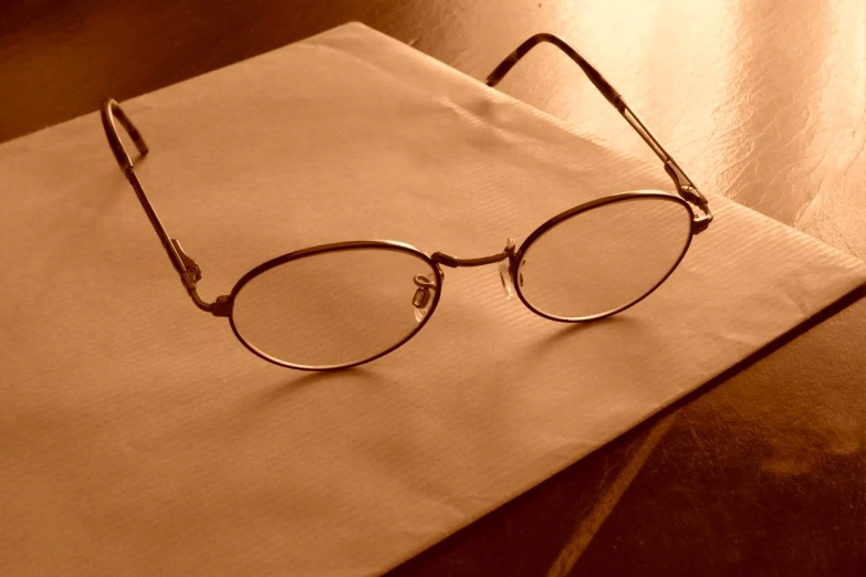 glasses sit on top of a piece of paper
