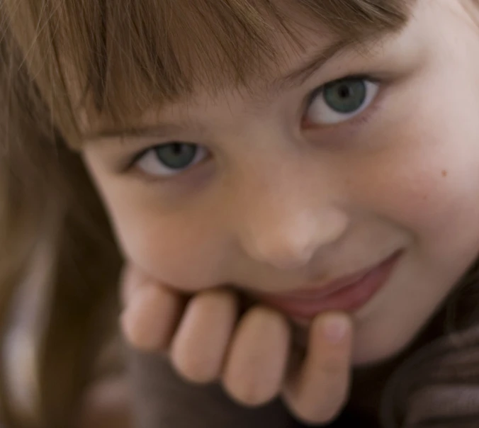 a close up of a child with blue eyes