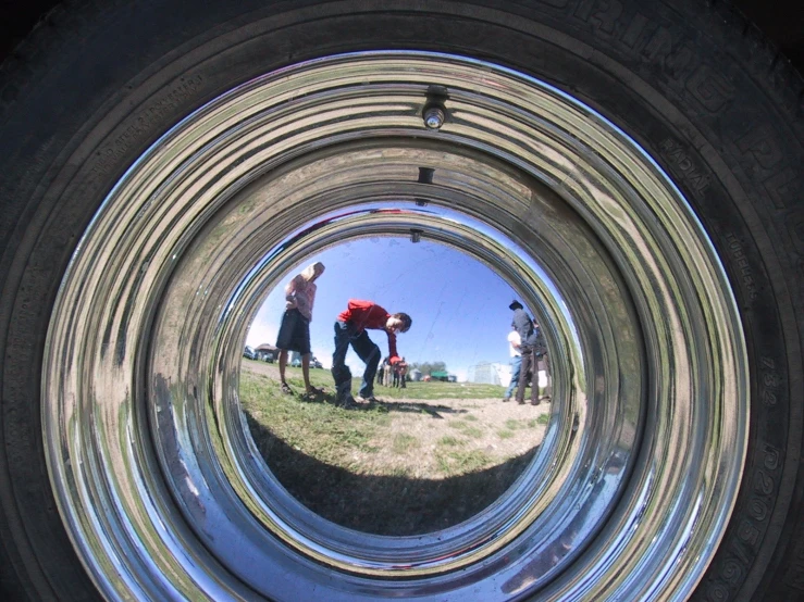 the reflection in the lens of a man standing in a field