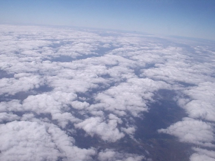 a blue sky with lots of clouds and some very large ones