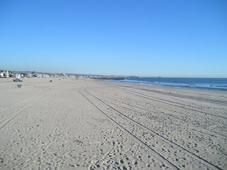 an empty beach on a sunny day with no waves