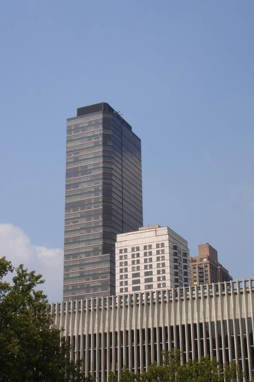 skyscrs in the city with trees and blue sky in the background