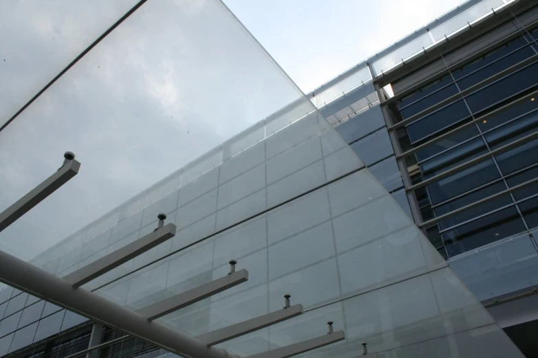 a street sign near an office building that has glass