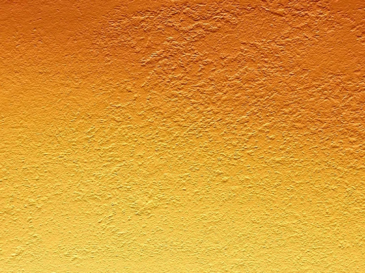 an orange painted wall with yellow and white paint