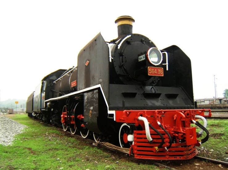 a black locomotive that is sitting on the tracks