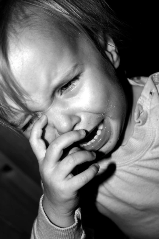 black and white pograph of a child holding a toothbrush