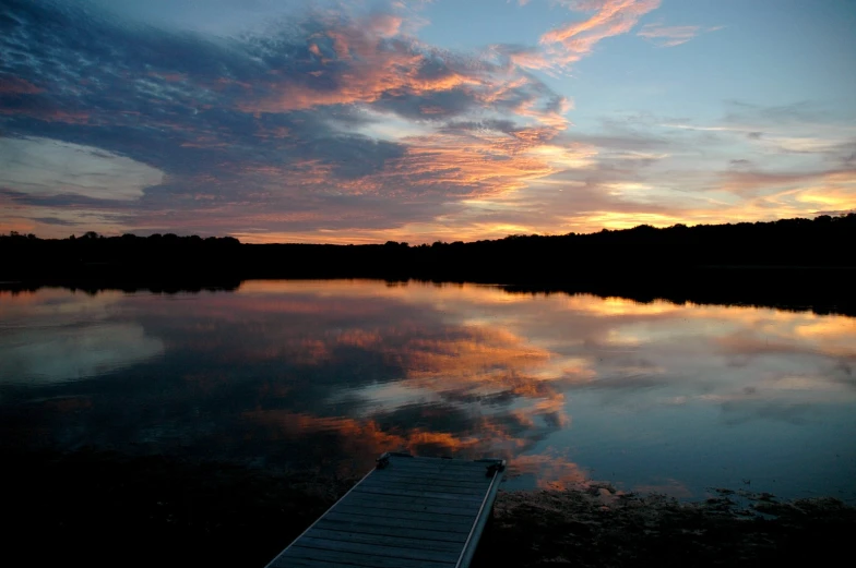 a dock sticking out of a body of water at night